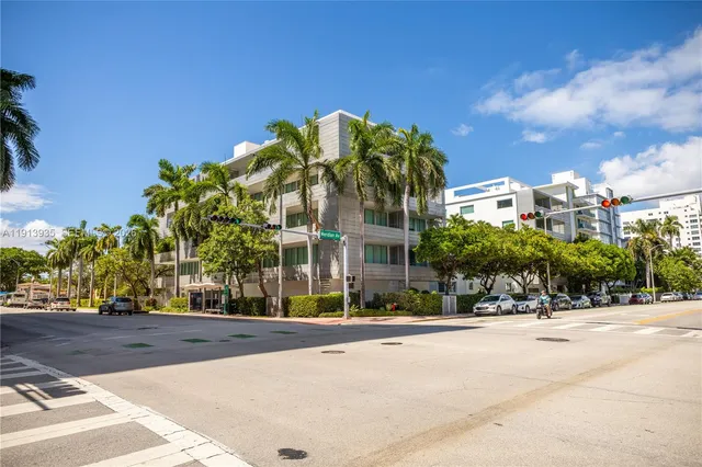 an aerial view of multi story residential apartment building with yard and outdoor seating