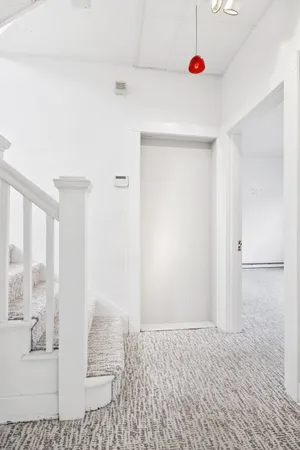 a view of staircase with white walls