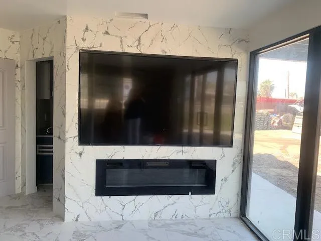 a living room with a fireplace and a flat screen tv