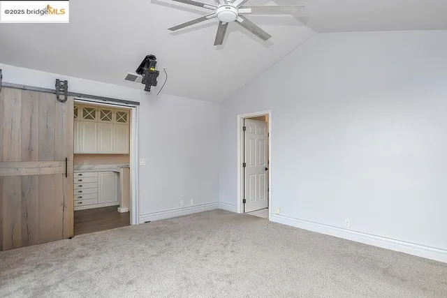 an empty room with windows and closet