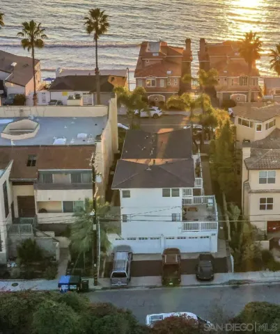 an aerial view of residential houses with parking