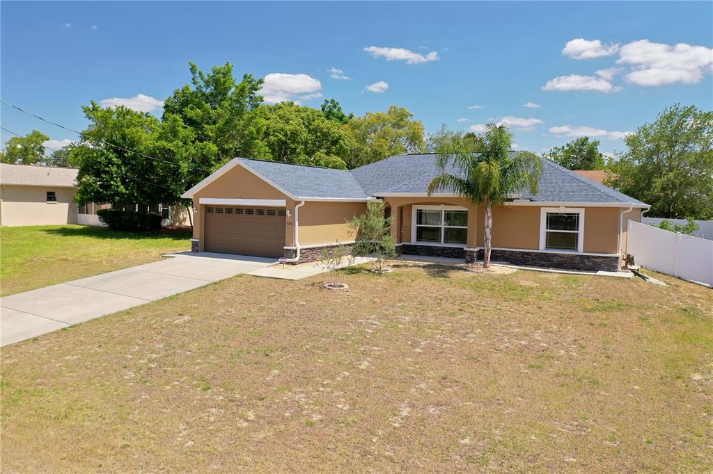 2252 Bishop Road Spring Hill, FL 34608 - Photo 1 of 1 a house with trees in the background