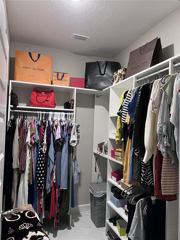 3834 Charter Road Lakeland, FL 33810 - Photo 18 of 39 a view of walk in closet with clothes and shoes