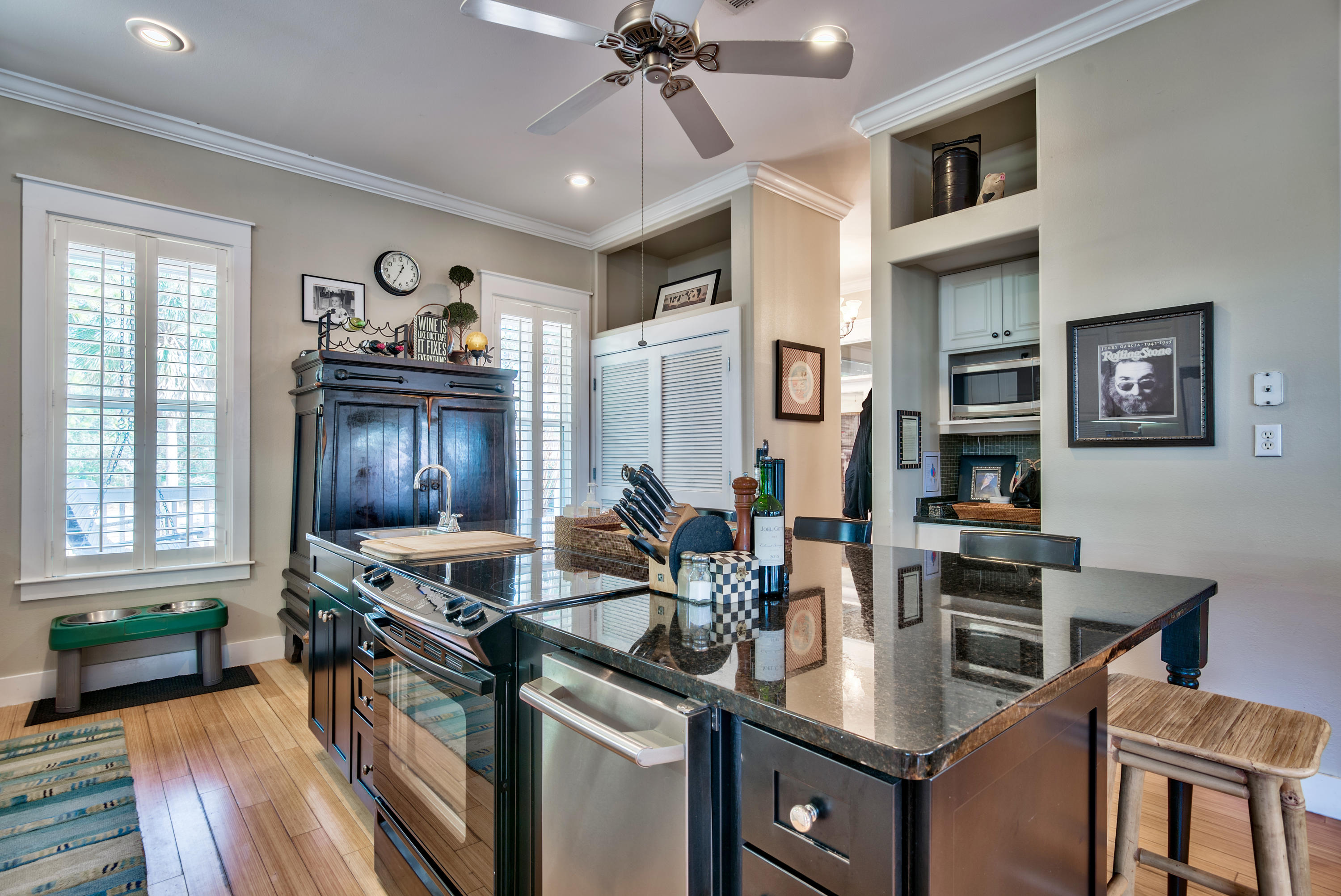 458 Bayou Circle Freeport, FL 32439 - Photo 18 of 33 a kitchen with stainless steel appliances granite countertop a stove top oven a sink a dining table and chairs with wooden floor