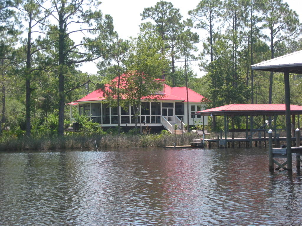 458 Bayou Circle Freeport, FL 32439 - Photo 32 of 33 a view of a lake with a table and chairs under an umbrella