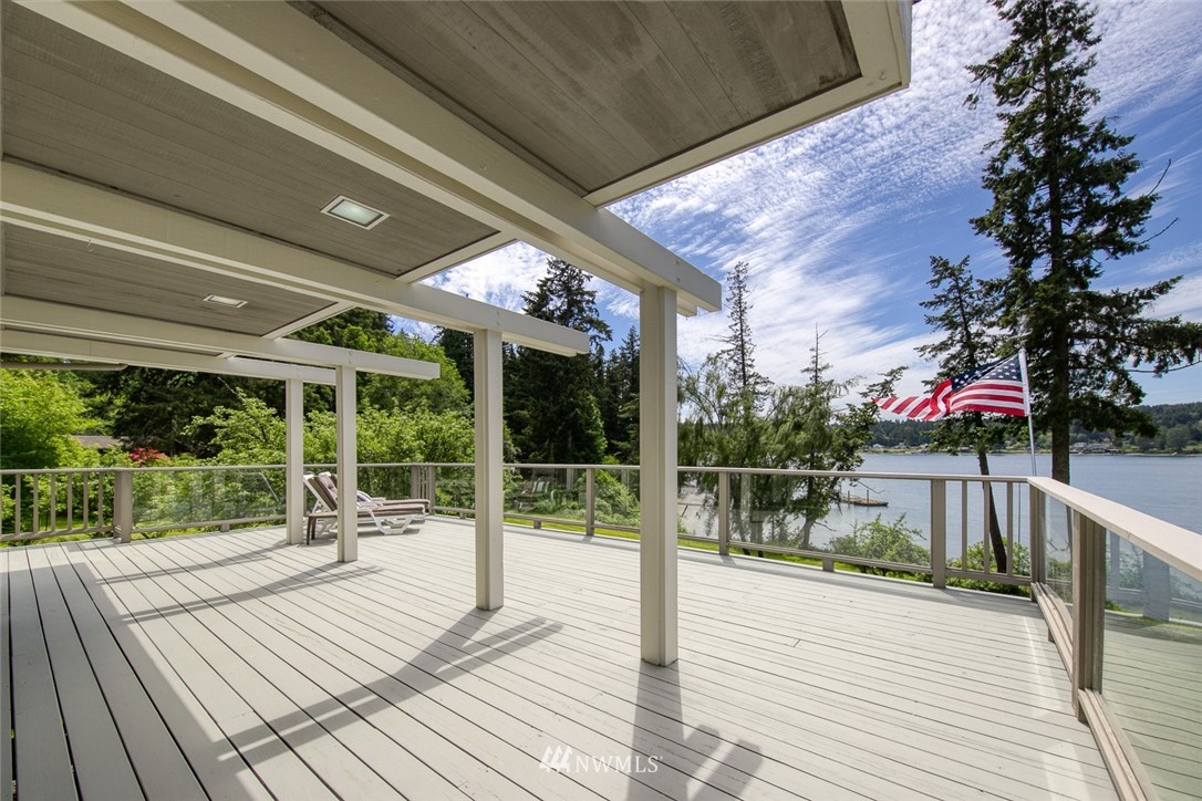 21005 Indianola Road Northeast Poulsbo, WA 98370 - Photo 14 of 40 a porch with seating space and hardwood floor