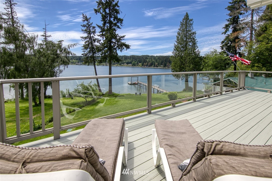 21005 Indianola Road Northeast Poulsbo, WA 98370 - Photo 15 of 40 a view of a balcony with floor to ceiling windows with wooden floor