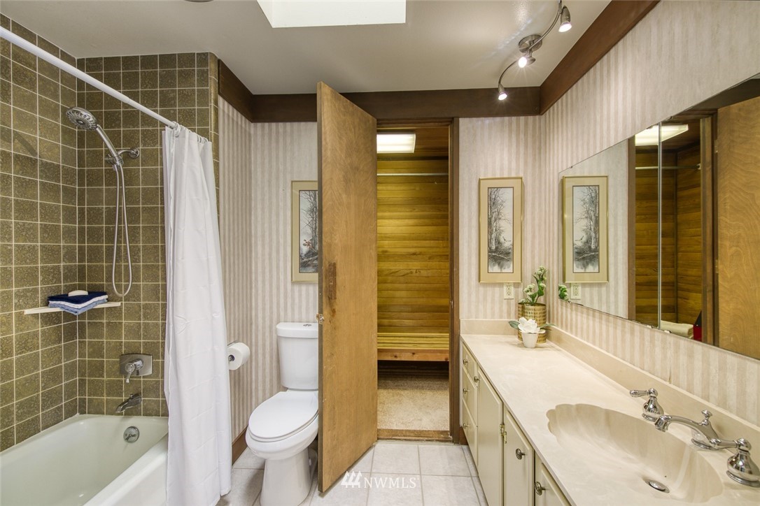 21005 Indianola Road Northeast Poulsbo, WA 98370 - Photo 18 of 40 a bathroom with a sink a toilet and shower