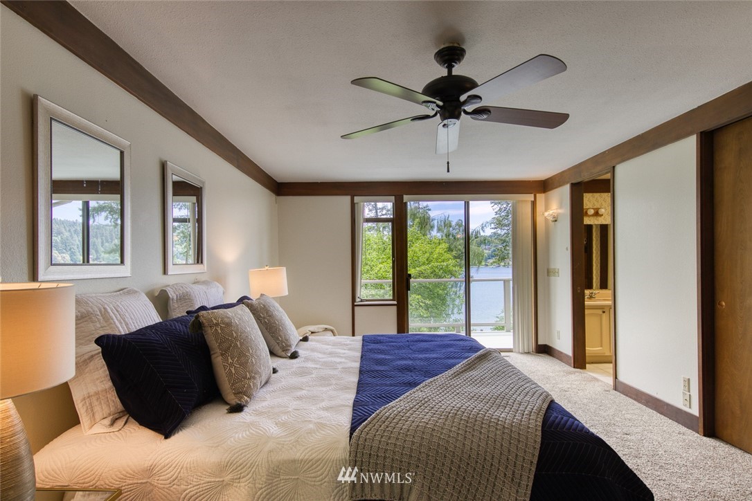 21005 Indianola Road Northeast Poulsbo, WA 98370 - Photo 21 of 40 a bedroom with a large bed and a large window