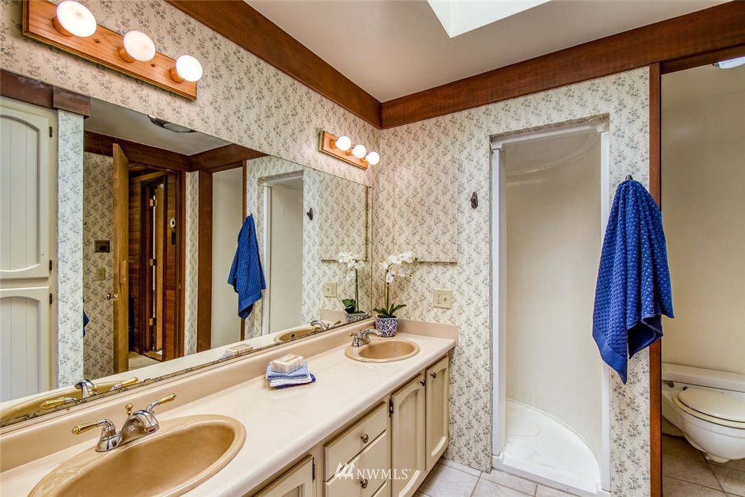 21005 Indianola Road Northeast Poulsbo, WA 98370 - Photo 23 of 40 a bathroom with a sink and a mirror