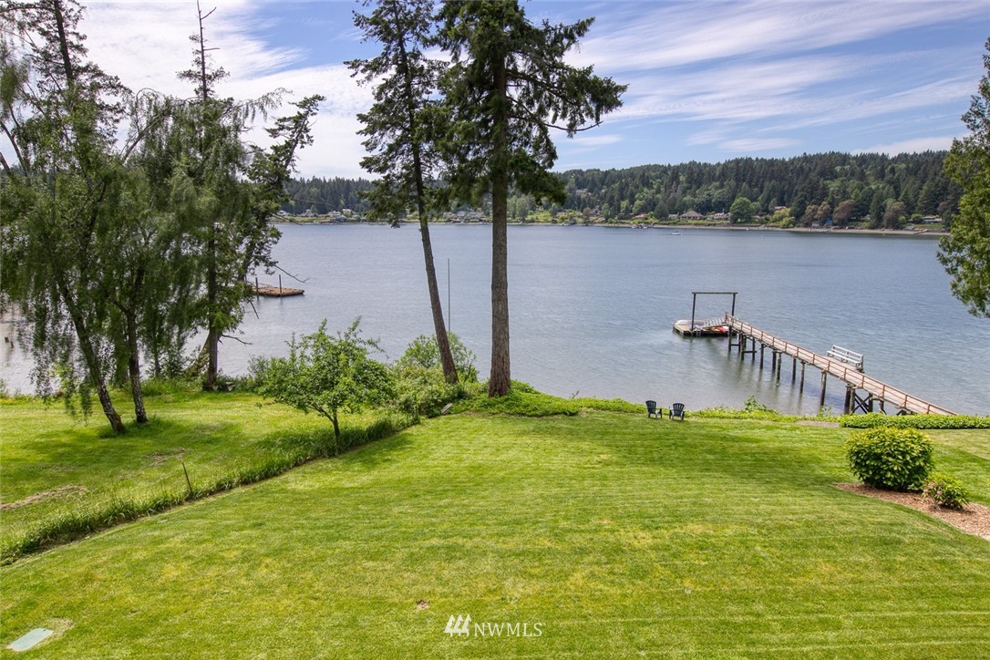 21005 Indianola Road Northeast Poulsbo, WA 98370 - Photo 25 of 40 a backyard of a house with lots of green space and lake view