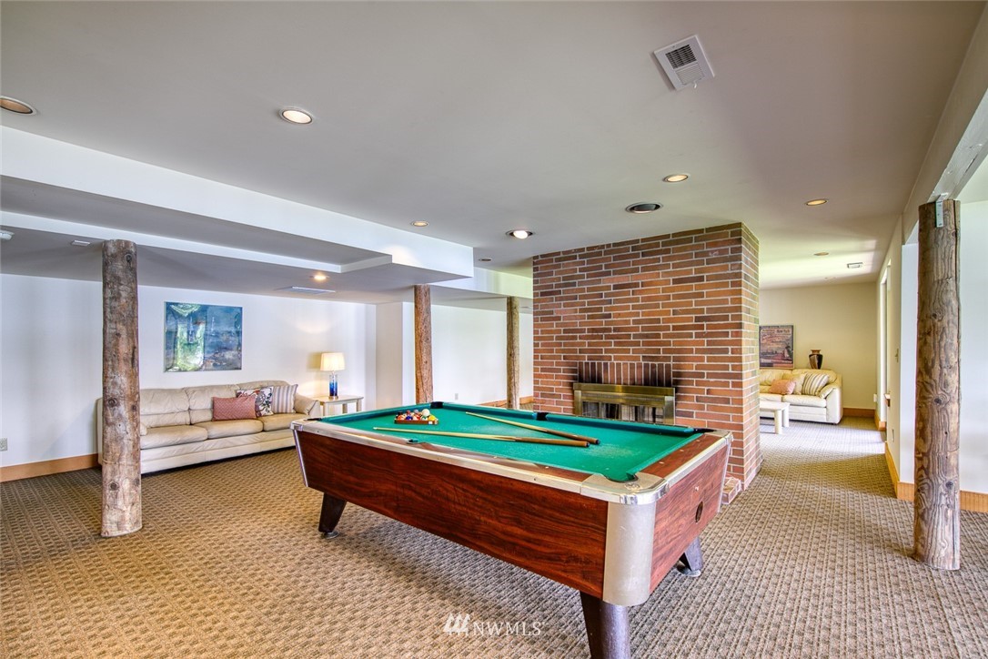 21005 Indianola Road Northeast Poulsbo, WA 98370 - Photo 28 of 40 a room with pool table table and sofas