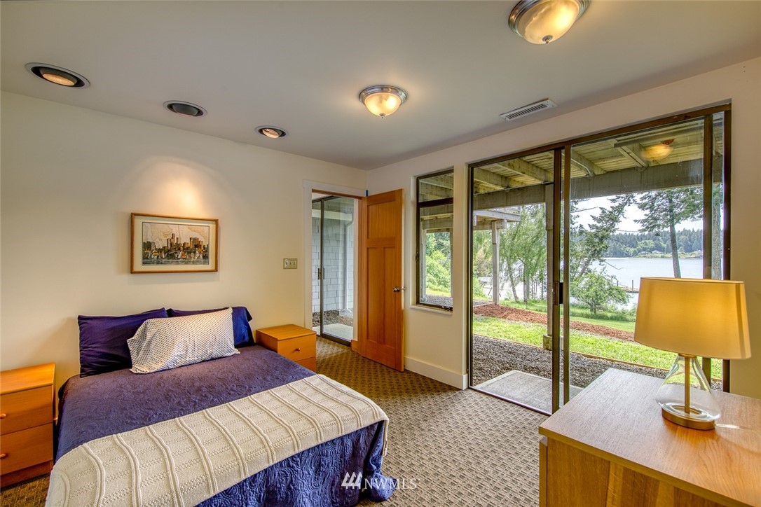 21005 Indianola Road Northeast Poulsbo, WA 98370 - Photo 32 of 40 a bedroom with a bed and lamp