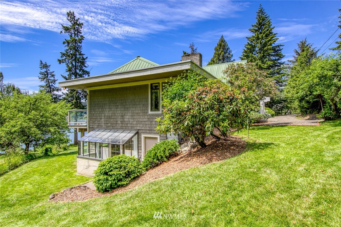 21005 Indianola Road Northeast Poulsbo, WA 98370 - Photo 36 of 40 a front view of a house with garden