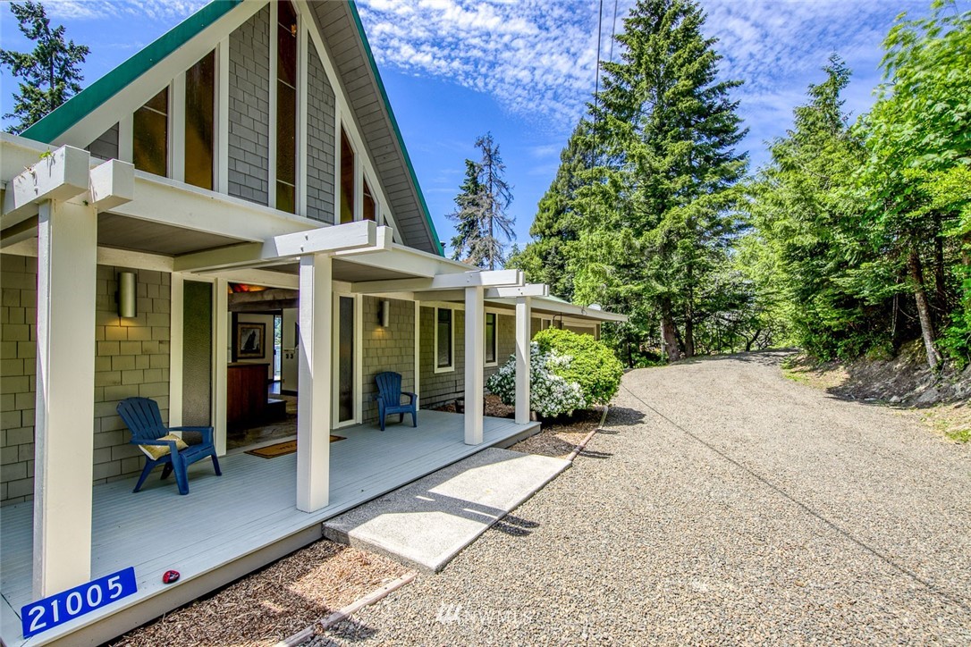 21005 Indianola Road Northeast Poulsbo, WA 98370 - Photo 37 of 40 a view of a house with a yard and balcony