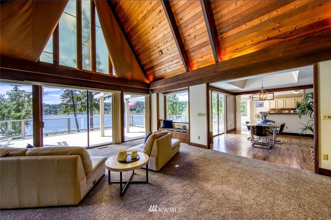 21005 Indianola Road Northeast Poulsbo, WA 98370 - Photo 8 of 40 a living room with furniture and floor to ceiling windows