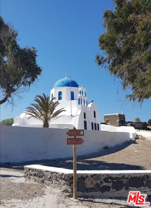 10 Santorini Greece undefined, undefined 0 - Photo 10 of 10 a view of a street with some trees
