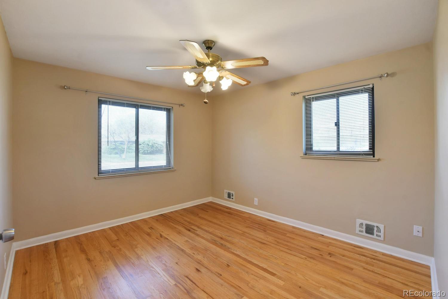 4660 Quay Street Wheat Ridge, CO 80033 - Photo 25 of 37 a view of an empty room with window and wooden floor