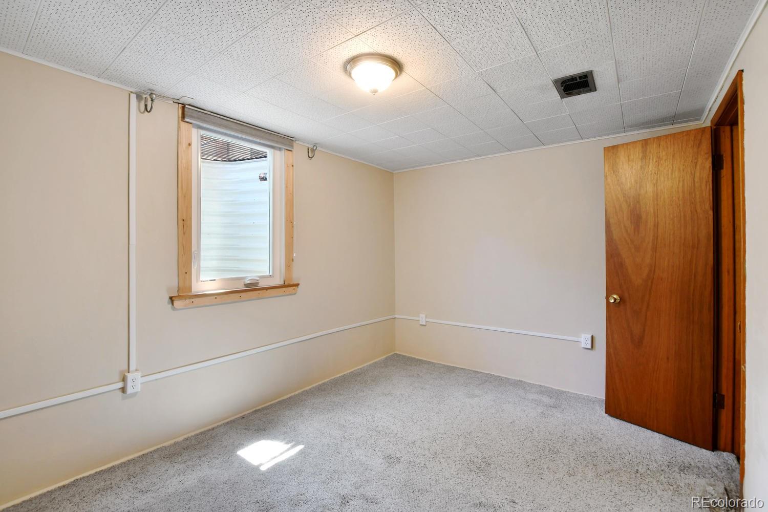 4660 Quay Street Wheat Ridge, CO 80033 - Photo 27 of 37 a view of an empty room with a window