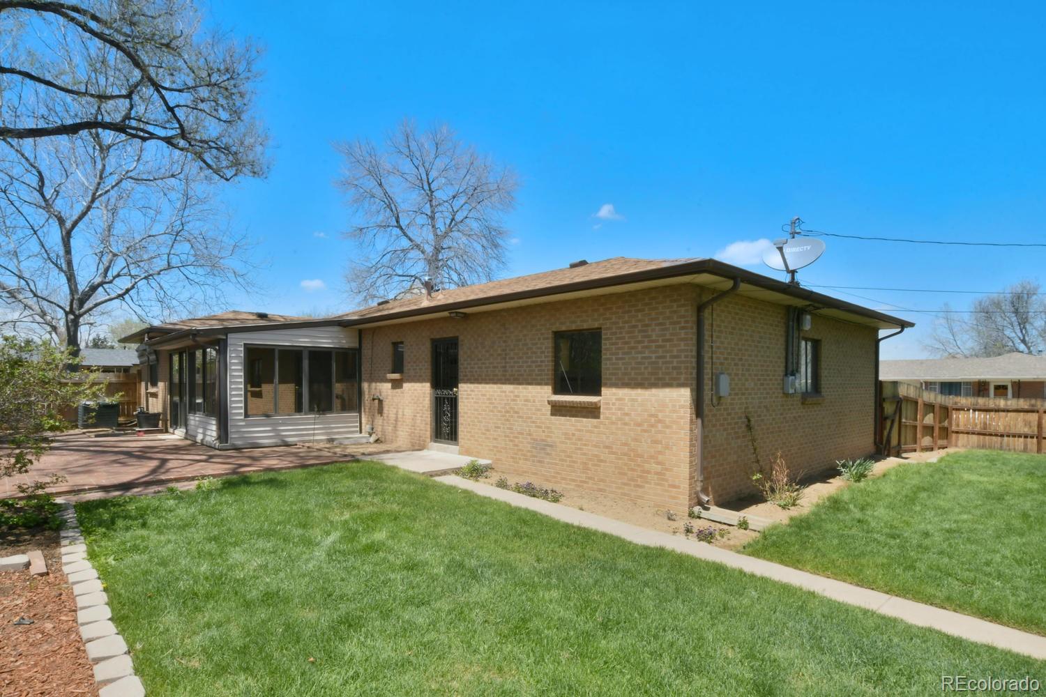 4660 Quay Street Wheat Ridge, CO 80033 - Photo 35 of 37 a front view of house with yard and trees in the background