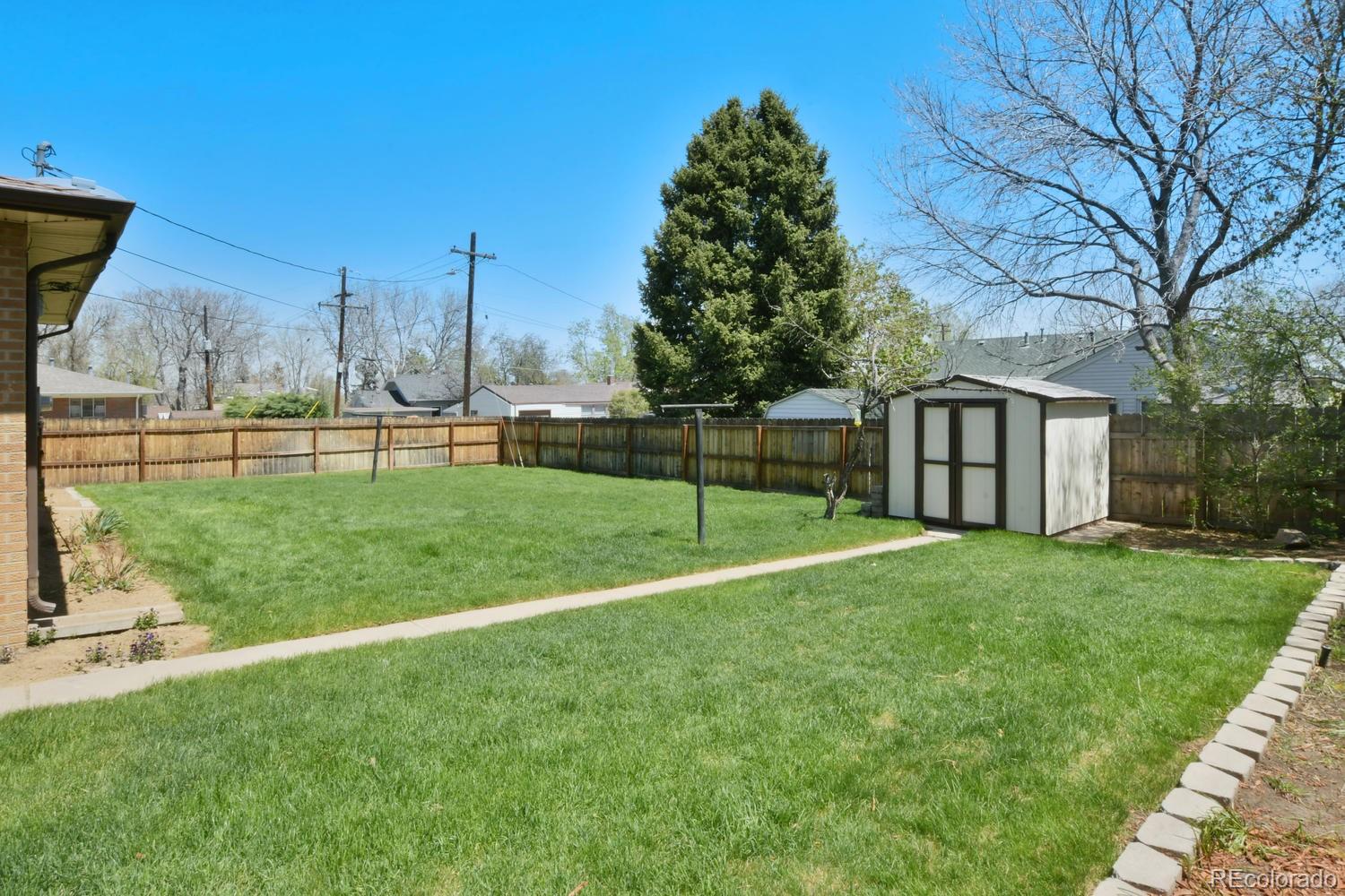 4660 Quay Street Wheat Ridge, CO 80033 - Photo 36 of 37 a view of a house with backyard and a tree