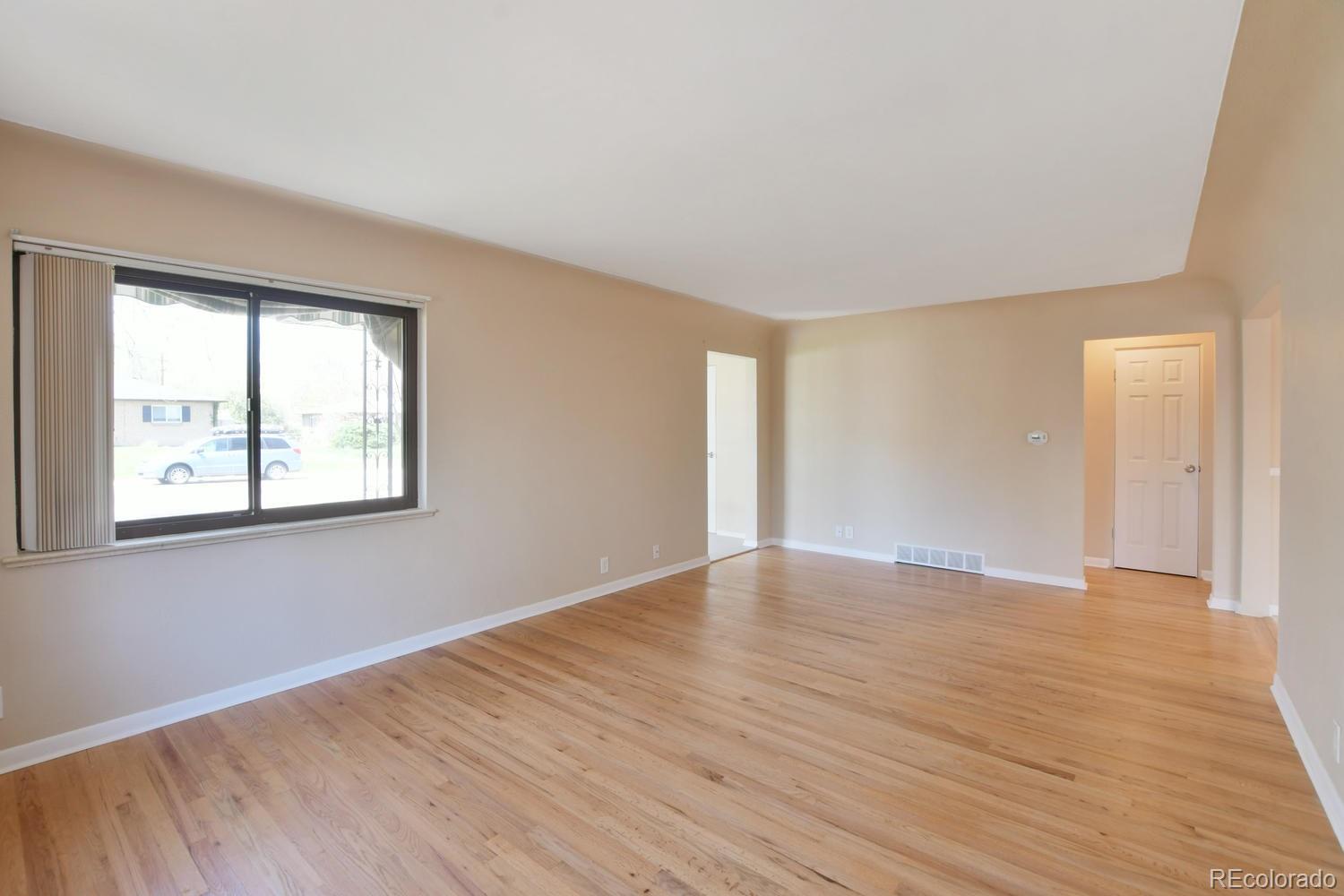 4660 Quay Street Wheat Ridge, CO 80033 - Photo 5 of 37 a view of an empty room with wooden floor and a window