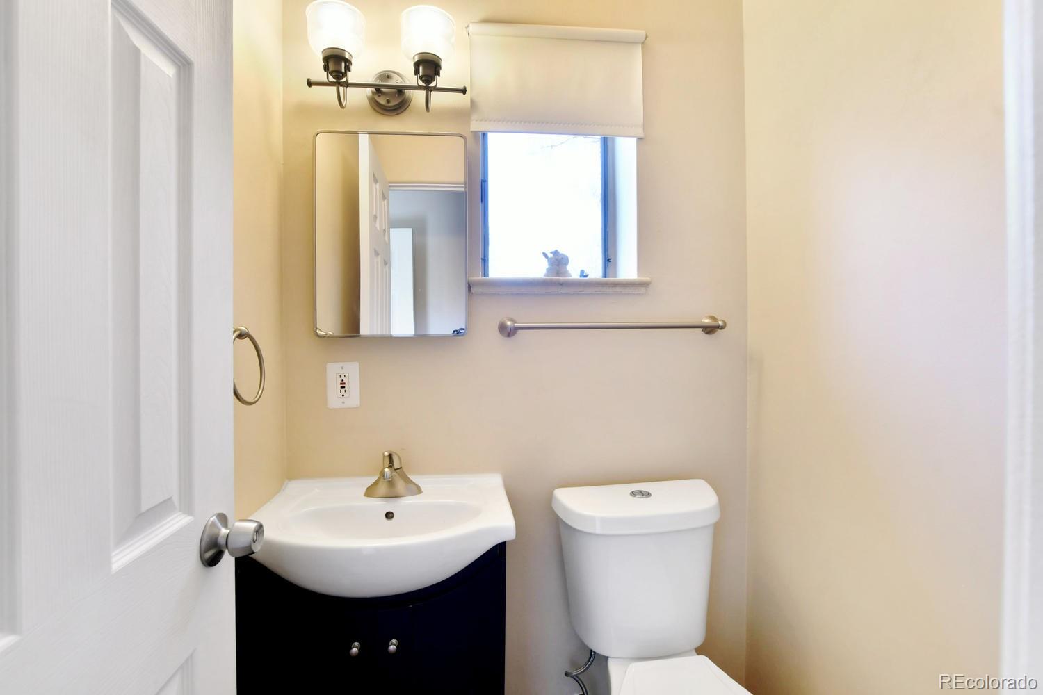 4660 Quay Street Wheat Ridge, CO 80033 - Photo 9 of 37 a bathroom with a sink and a toilet