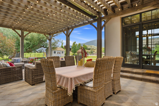 71 Farm Road Midway, UT 84049 - Photo 30 of 92 Expansive outdoor patio featuring a wood pergola, string lighting, and direct access to interior spaces through large glass doors
