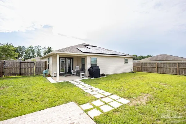 a view of a house with a yard and sitting area