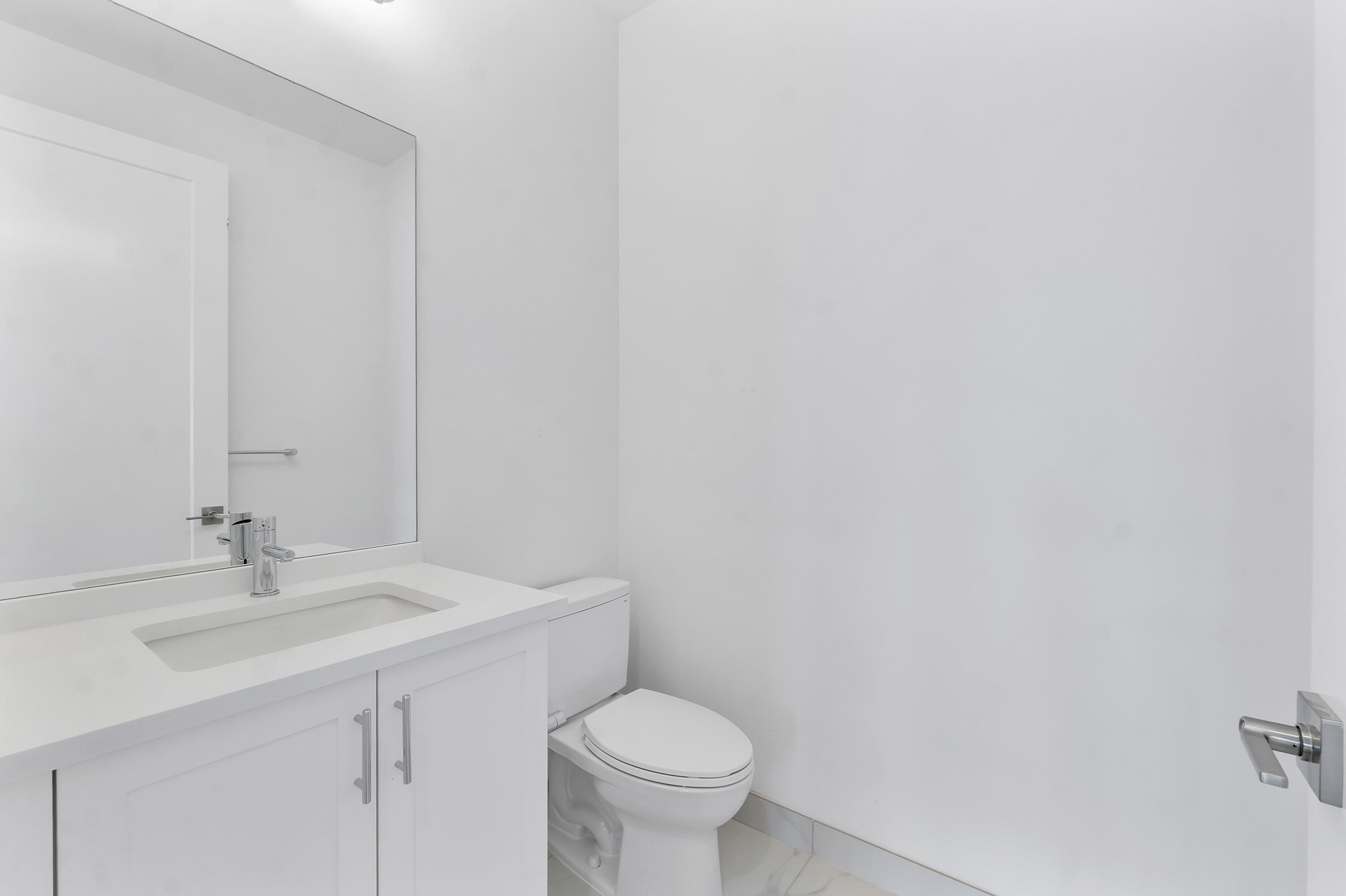 9322 Sunflower Mdw Road Boca Raton, FL 33434 - Photo 43 of 87 a bathroom with a sink a toilet and a mirror