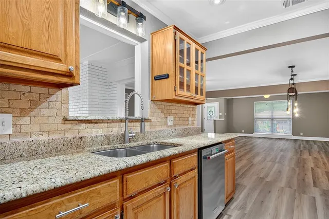 a kitchen with granite countertop a sink and cabinets