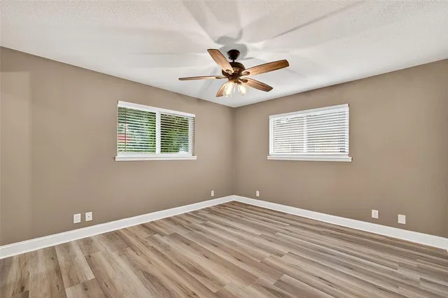 a view of a room with a ceiling fan and a window