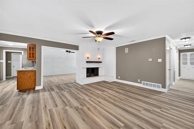 wooden floor in an empty room with a fireplace