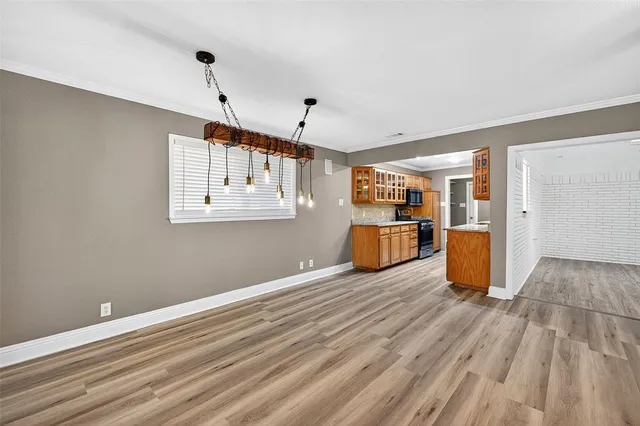 a view of a room with wooden floor and windows