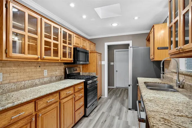 a kitchen with granite countertop wooden cabinets and a granite counter tops