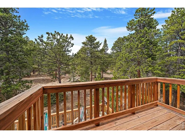 a view of roof deck with wooden floor and fence