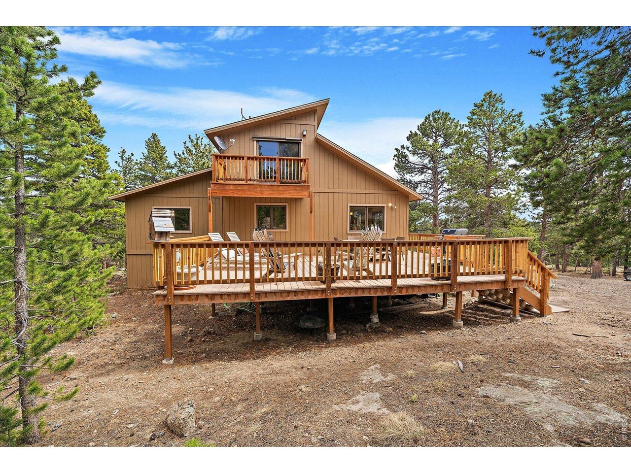 902 Rock Lake Road Ward, CO 80481 - Photo 2 of 32 a view of a house with a yard and deck