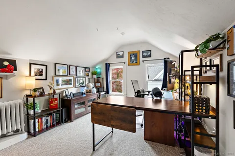 a living room with lots of furniture and baby bed