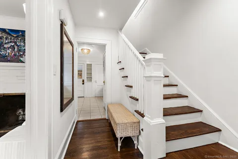 a view of entryway and hall with wooden floor