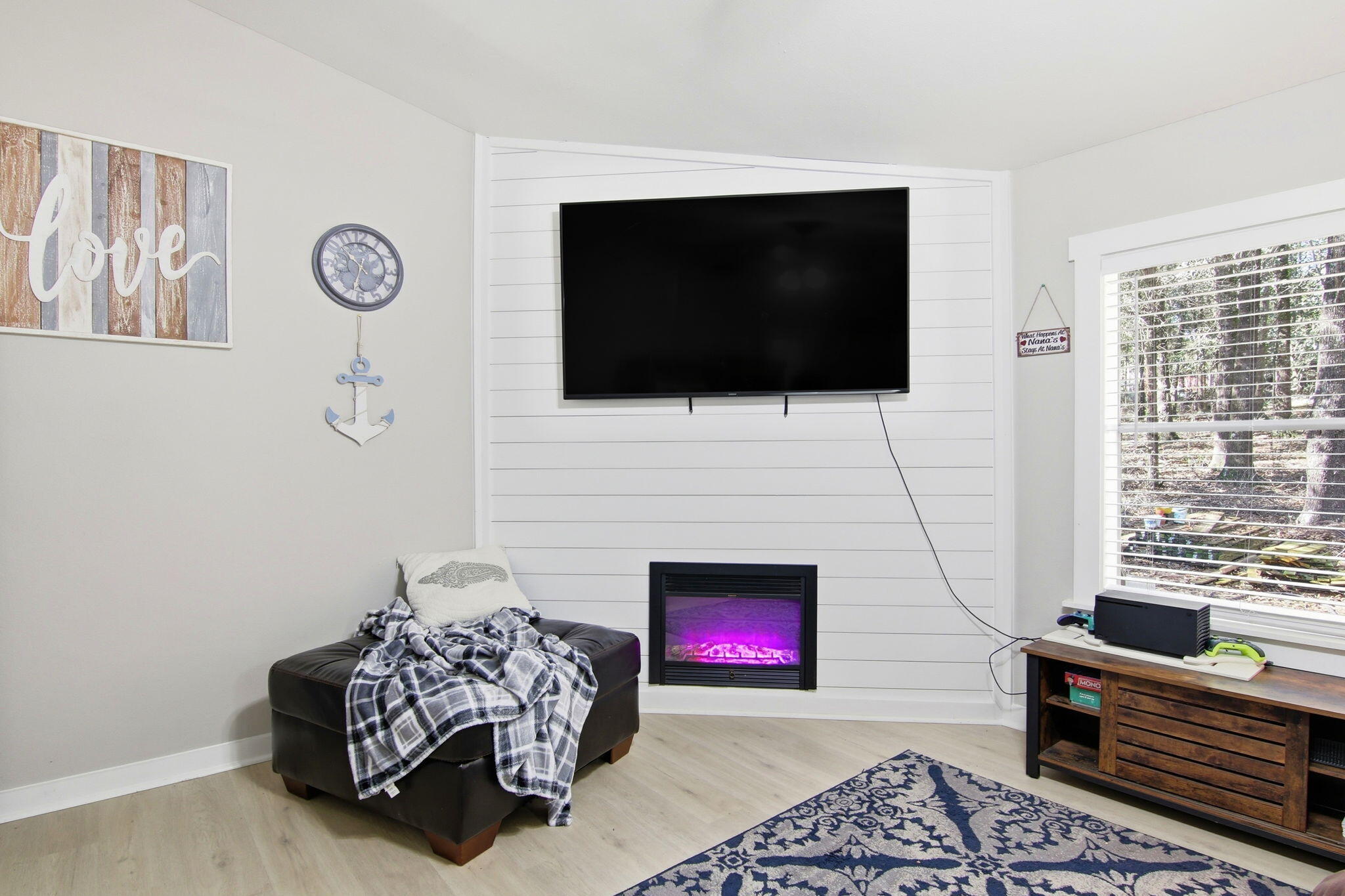 6108 Old River Road Baker, FL 32531 - Photo 15 of 40 a living room with furniture a flat screen tv and a fireplace