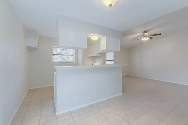 a view of kitchen with center island and windows