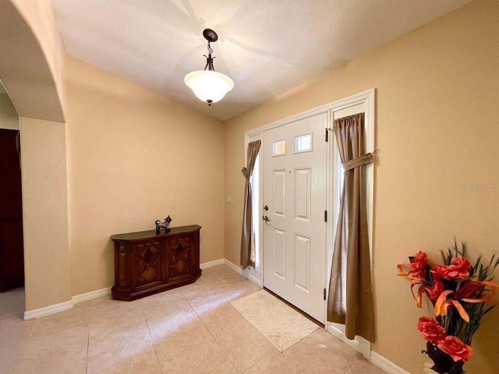 16026 Southwest 14th Avenue Road Ocala, FL 34473 - Photo 20 of 79 a spacious bedroom with a bed and a potted plant