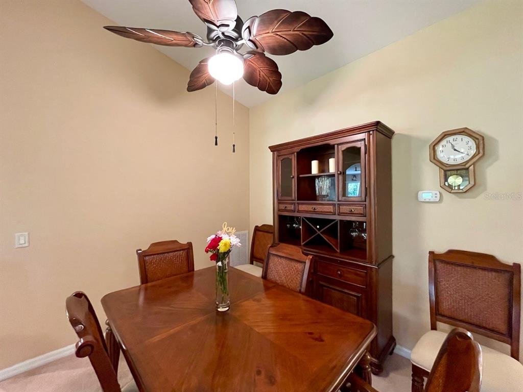 16026 Southwest 14th Avenue Road Ocala, FL 34473 - Photo 21 of 79 a view of a dining room with furniture and chandelier