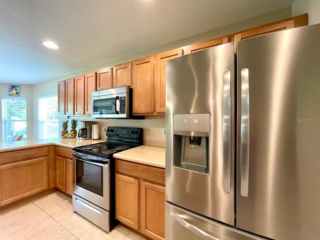 16026 Southwest 14th Avenue Road Ocala, FL 34473 - Photo 34 of 79 a kitchen with stainless steel appliances a refrigerator sink and microwave