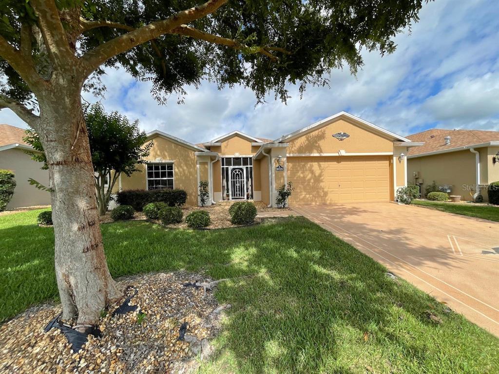 16026 Southwest 14th Avenue Road Ocala, FL 34473 - Photo 4 of 79 a front view of a house with a garden and yard