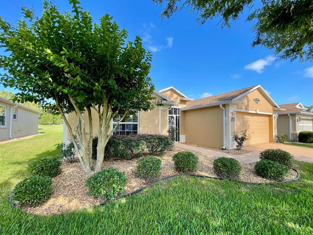 16026 Southwest 14th Avenue Road Ocala, FL 34473 - Photo 5 of 79 a front view of a house with a yard and garage