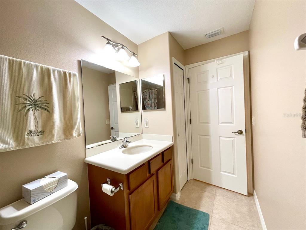 16026 Southwest 14th Avenue Road Ocala, FL 34473 - Photo 57 of 79 a bathroom with a sink mirror and a toilet