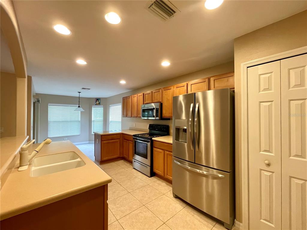 16026 Southwest 14th Avenue Road Ocala, FL 34473 - Photo 79 of 79 a kitchen with stainless steel appliances granite countertop a refrigerator and a stove top oven