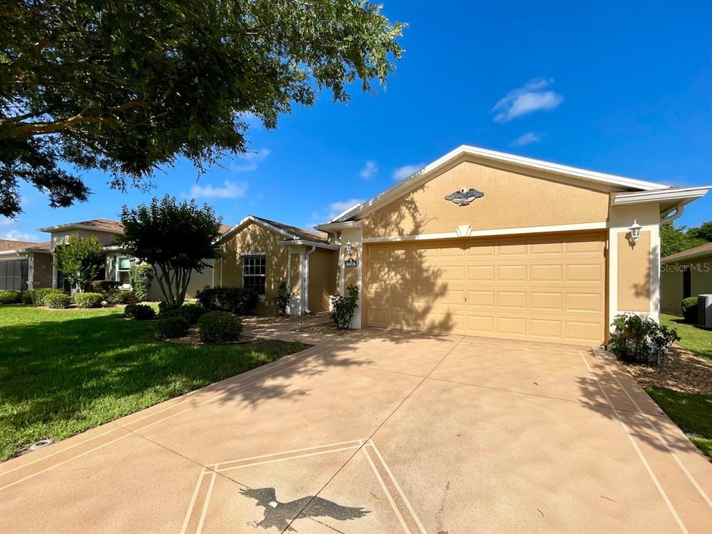 16026 Southwest 14th Avenue Road Ocala, FL 34473 - Photo 9 of 79 a front view of a house with a yard