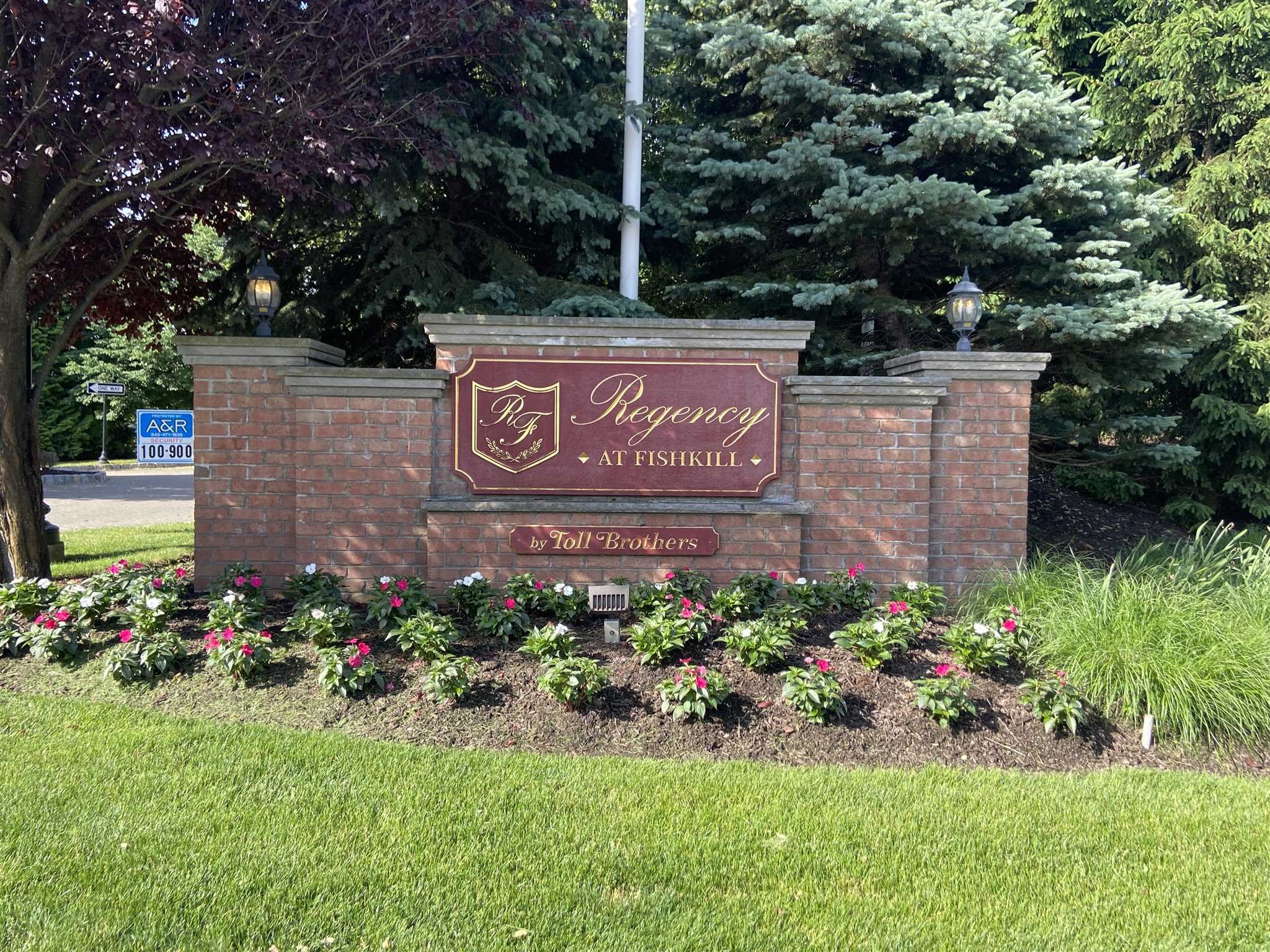 643 Regency Drive Fishkill, NY 12524 - Photo 2 of 37 a sign that is sitting in front of flowers